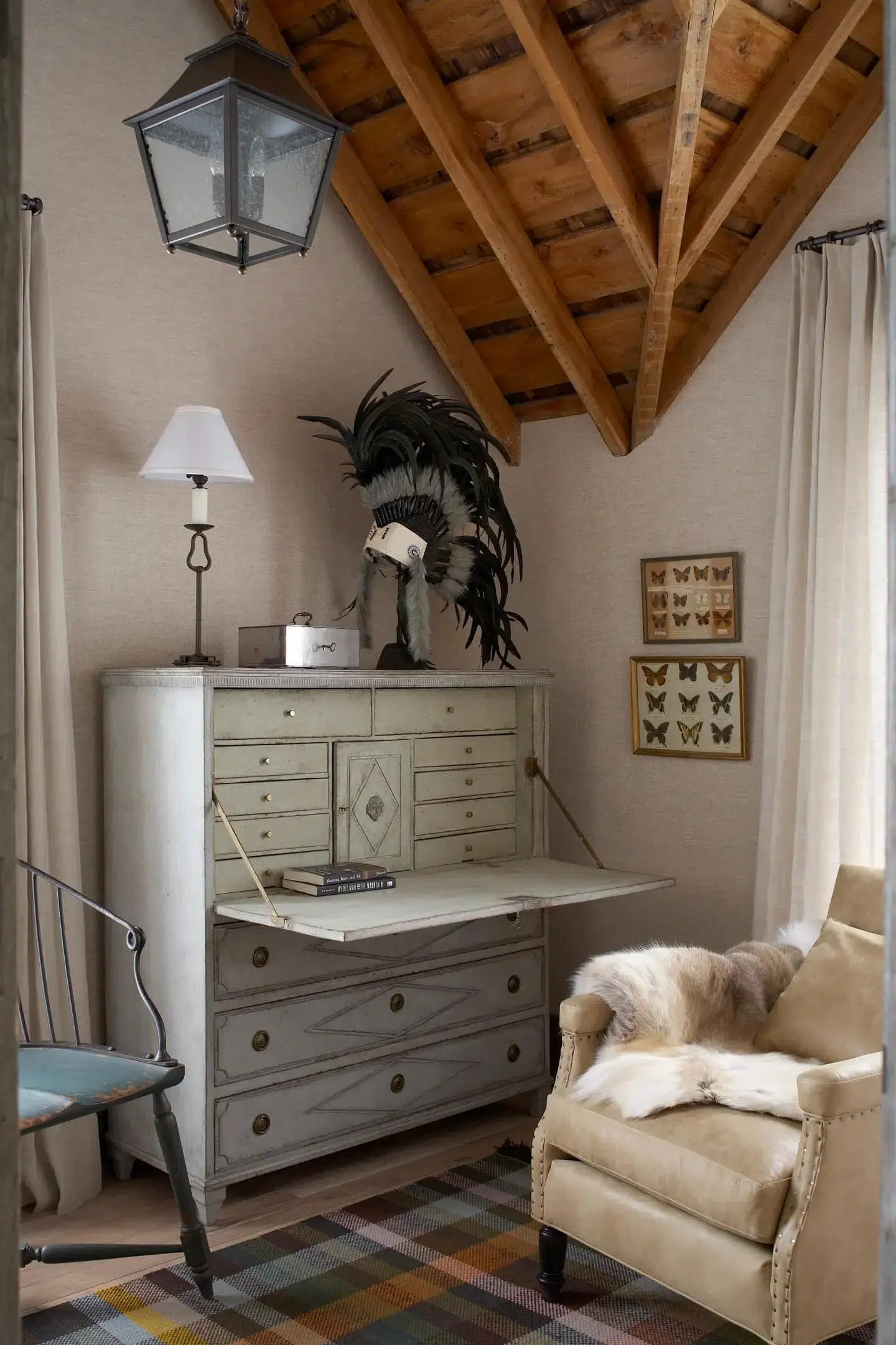 A white-washed antique Swedish secrétaire in the study of a Montana home designed by the firm Koo de Kir